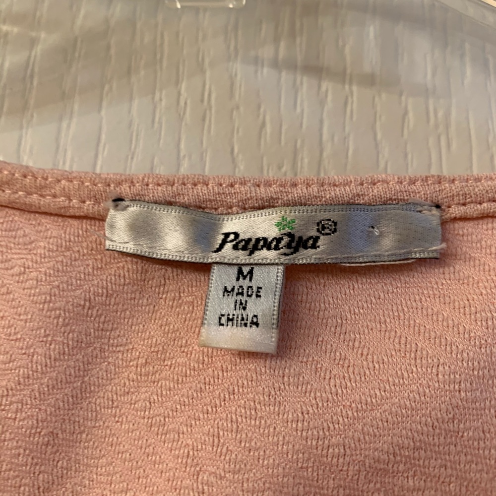 Peach colored knee, a-length, sleeveless dress